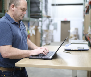 Warehouse manager working on a laptop